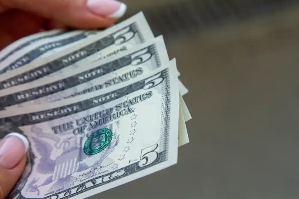 Stack of five dollar bills that are saved