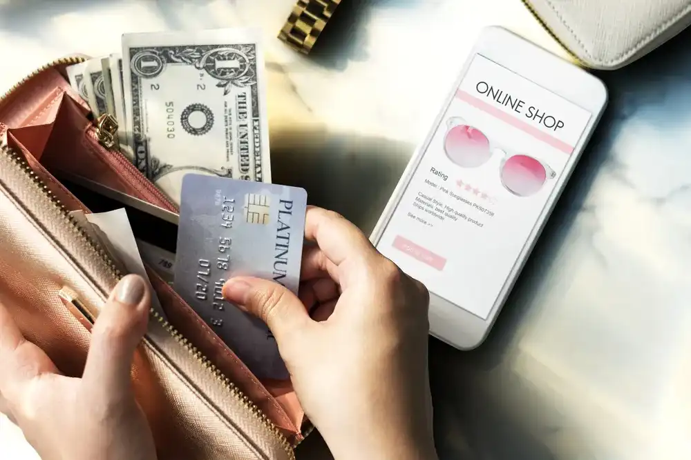 A person taking out their credit card to online shop