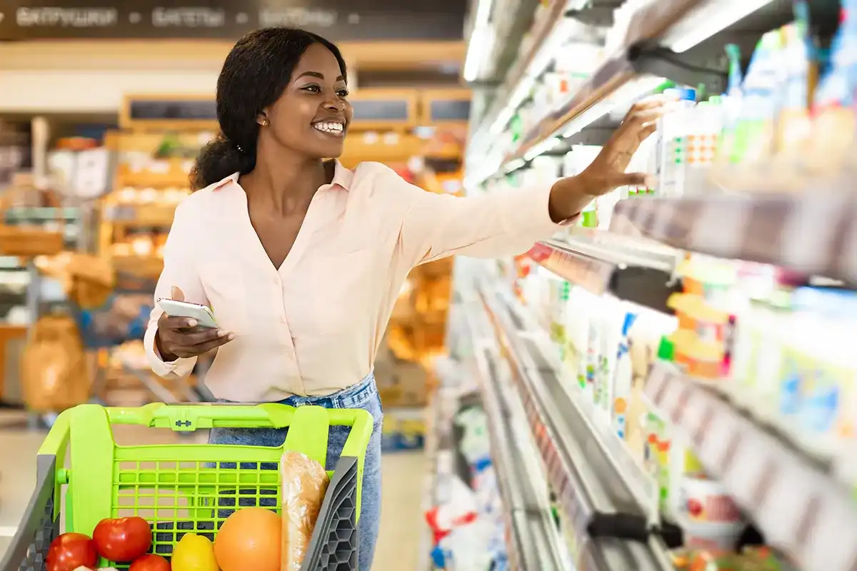 Woman using a coupon app to save money at the grocery store