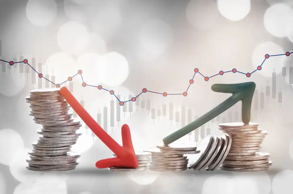 Arrows pointing down and up on top of stacks of coins