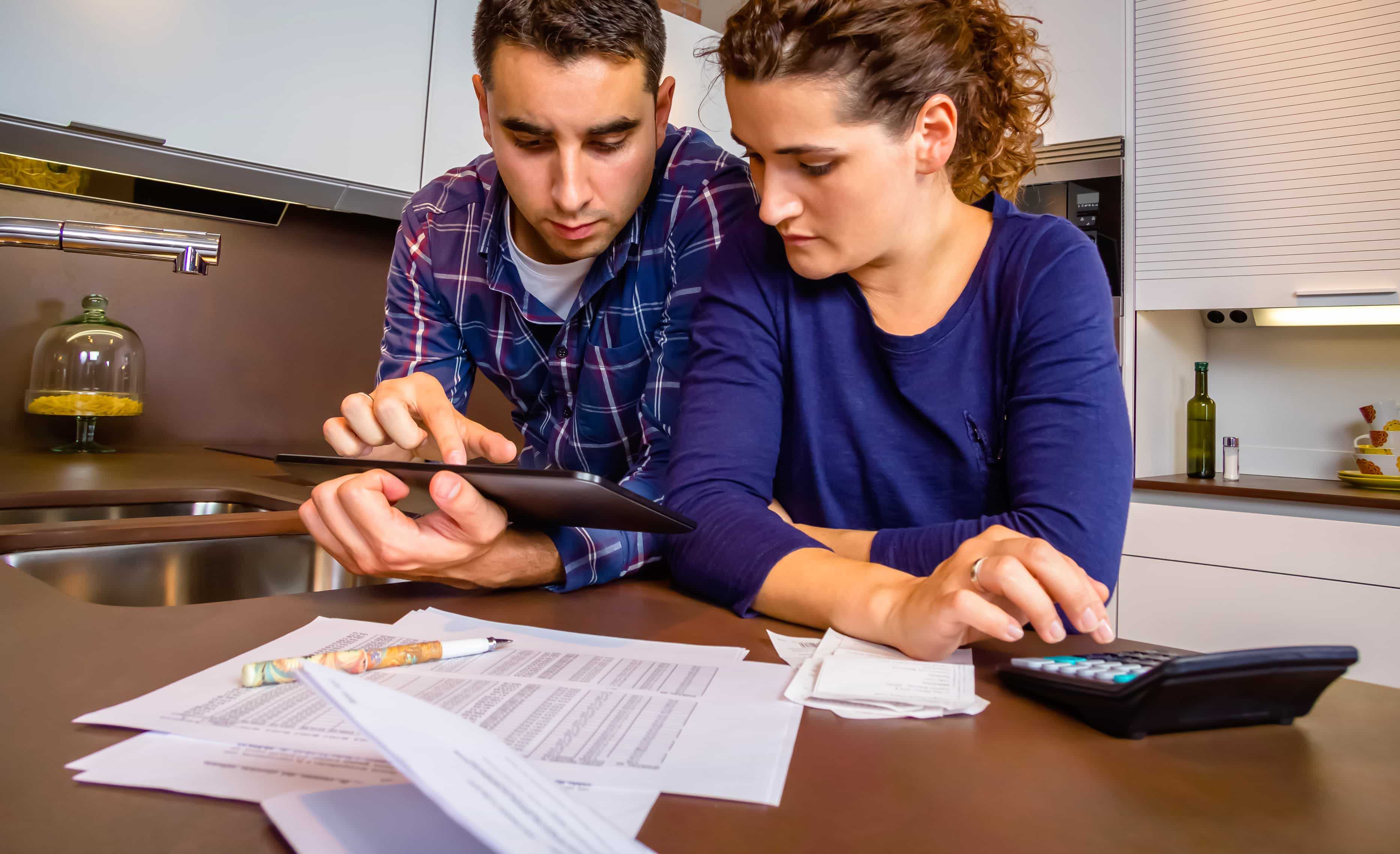 Couple reviewing their finances to take out their first title loan 