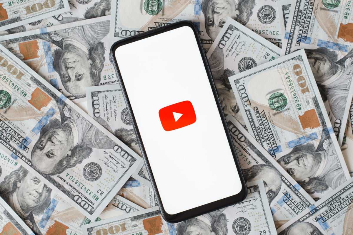 YouTube on a phone atop money