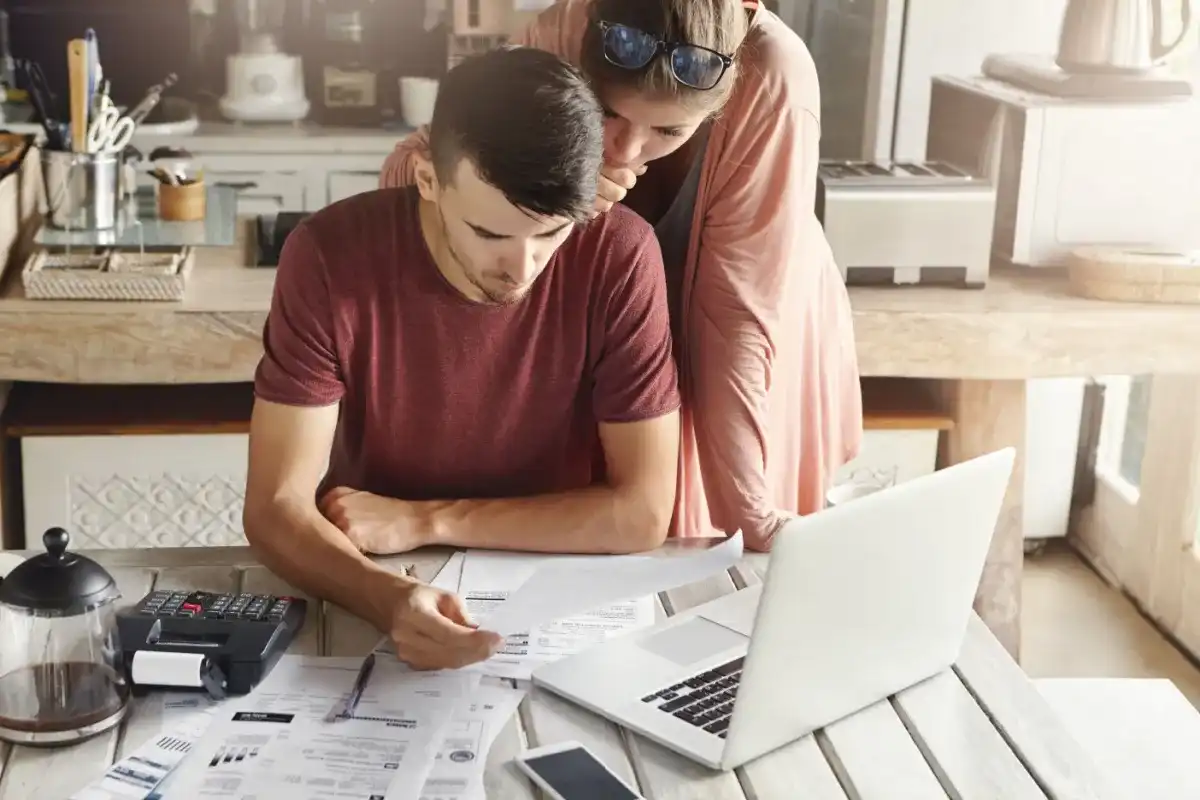 Couple reviewing loan types online, including a title loan