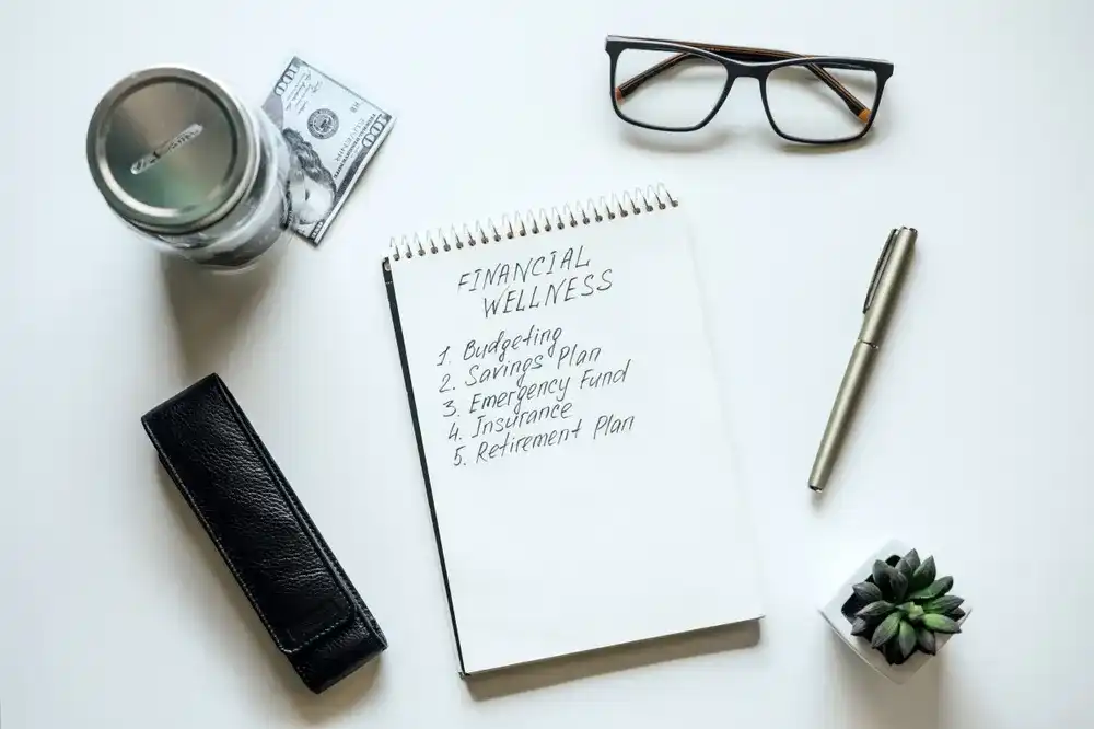 A notepad reading "Financial Wellness" and various tips