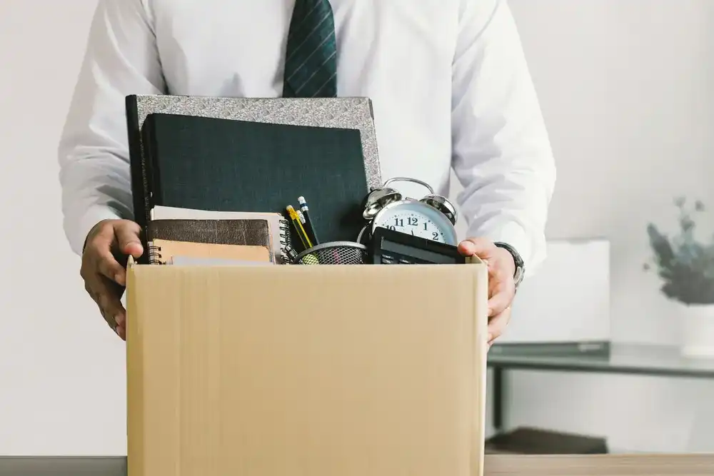 Someone packing up their office for a career transition