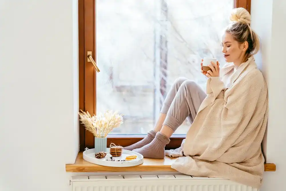 A woman enjoying cost effective heating solutions