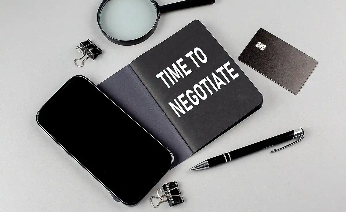 A planner with "Time to Negotiate" on the front