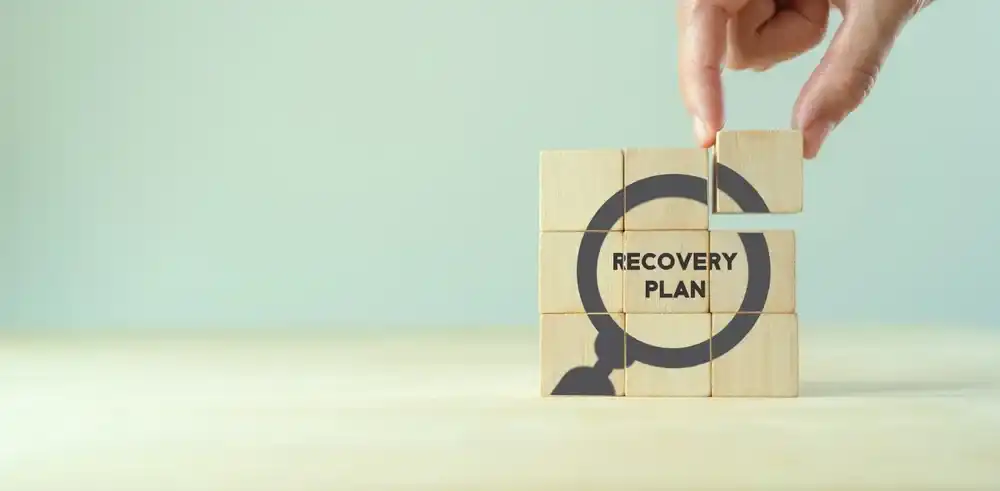 Wooden blocks reading "Recovery Plan"