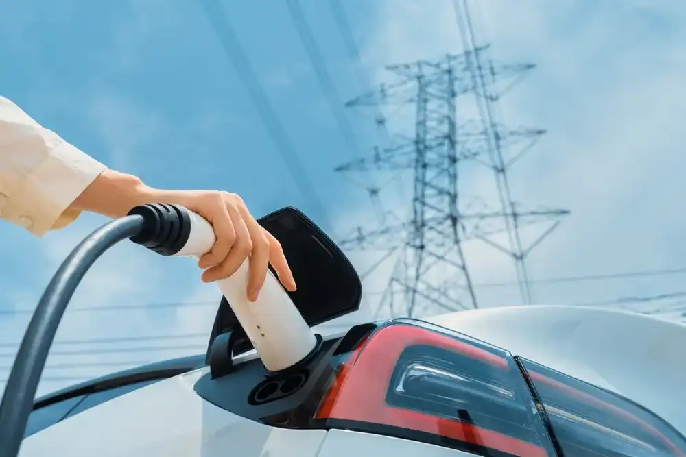 Person charging their electric vehicle