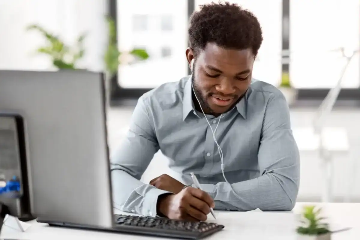 Man listening to a top financial podcast while working