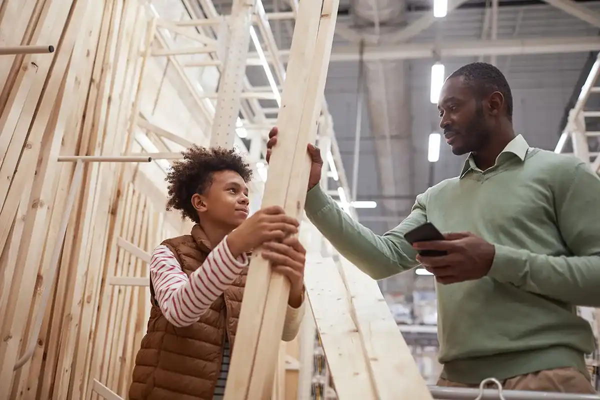 A father and his son buying wood planks for a home improvement project