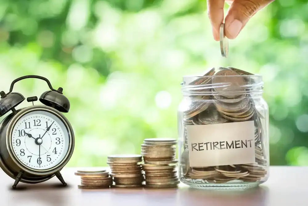 Someone putting coins into a jar that says "Retirement"