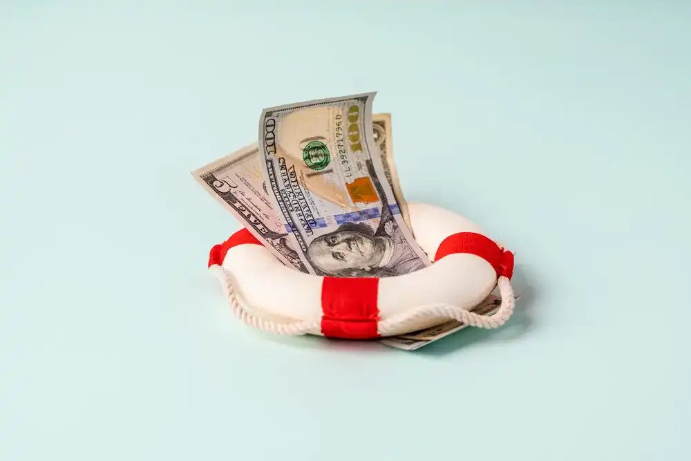 Money in a life raft representing economic recovery