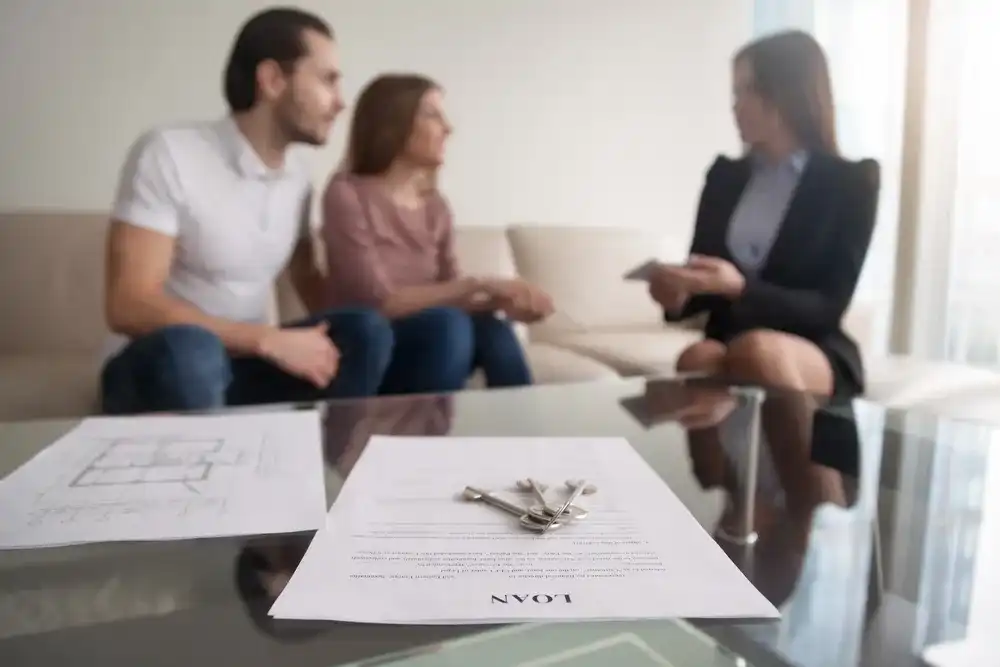A couple meeting with a financial advisor discussing a loan