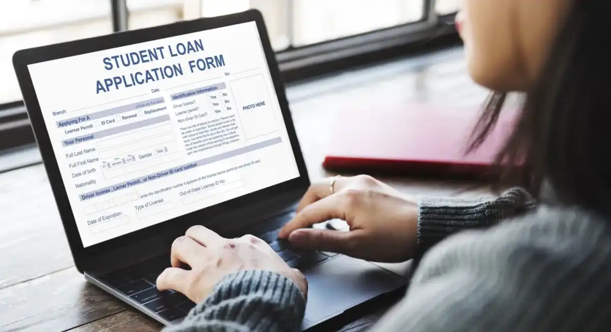 A student working on a Student Loan Application Form