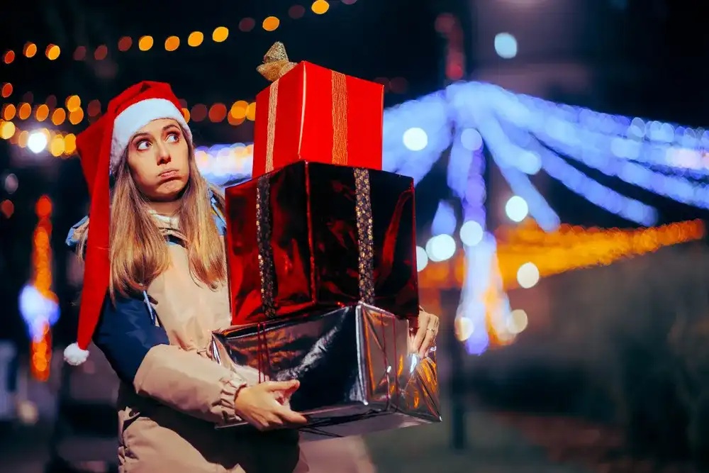 A woman carrying Christmas gifts