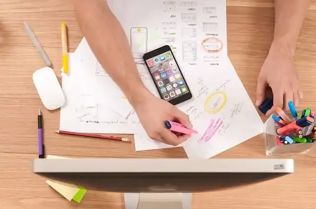 Someone working on a vision board to visualize their financial success