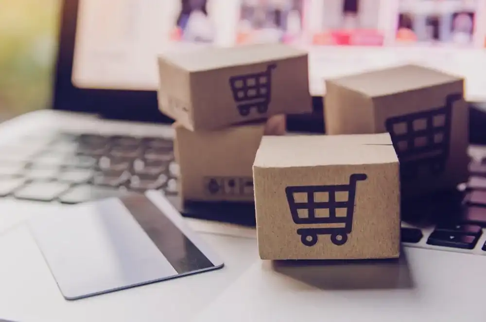 Boxes and credit card atop a laptop from online shopping