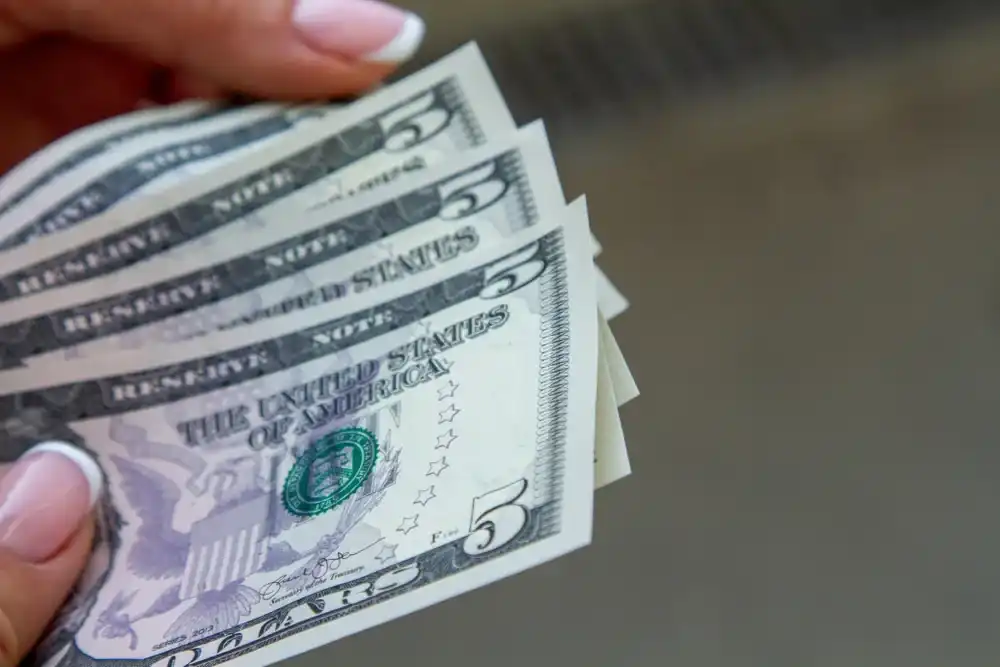 A stack of $5 dollars bills that were saved