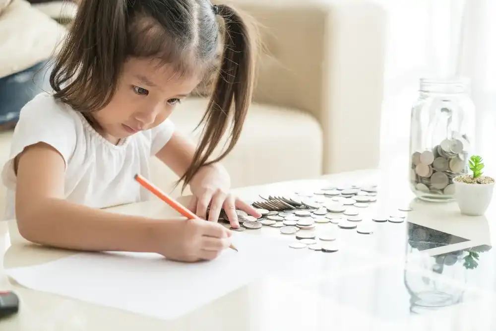 A child working on their money skills