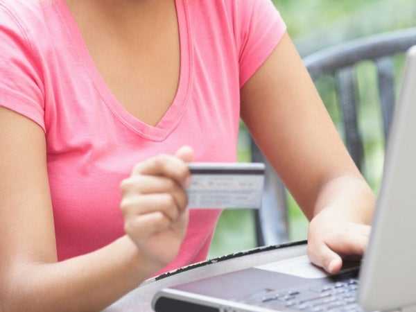 Woman putting in her card information to receive money from a installment loan