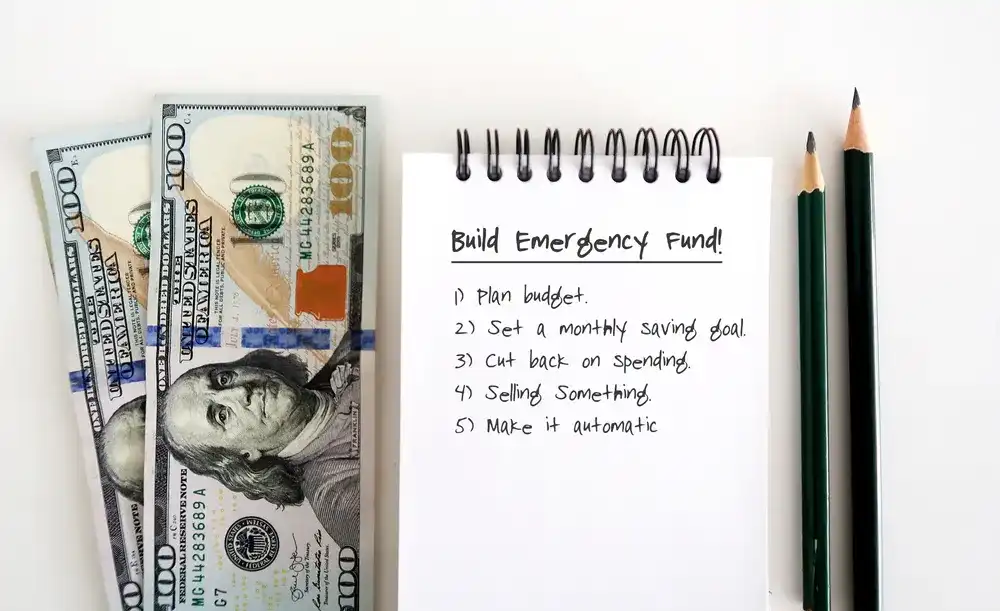 A notebook with a list on how to build an emergency fund