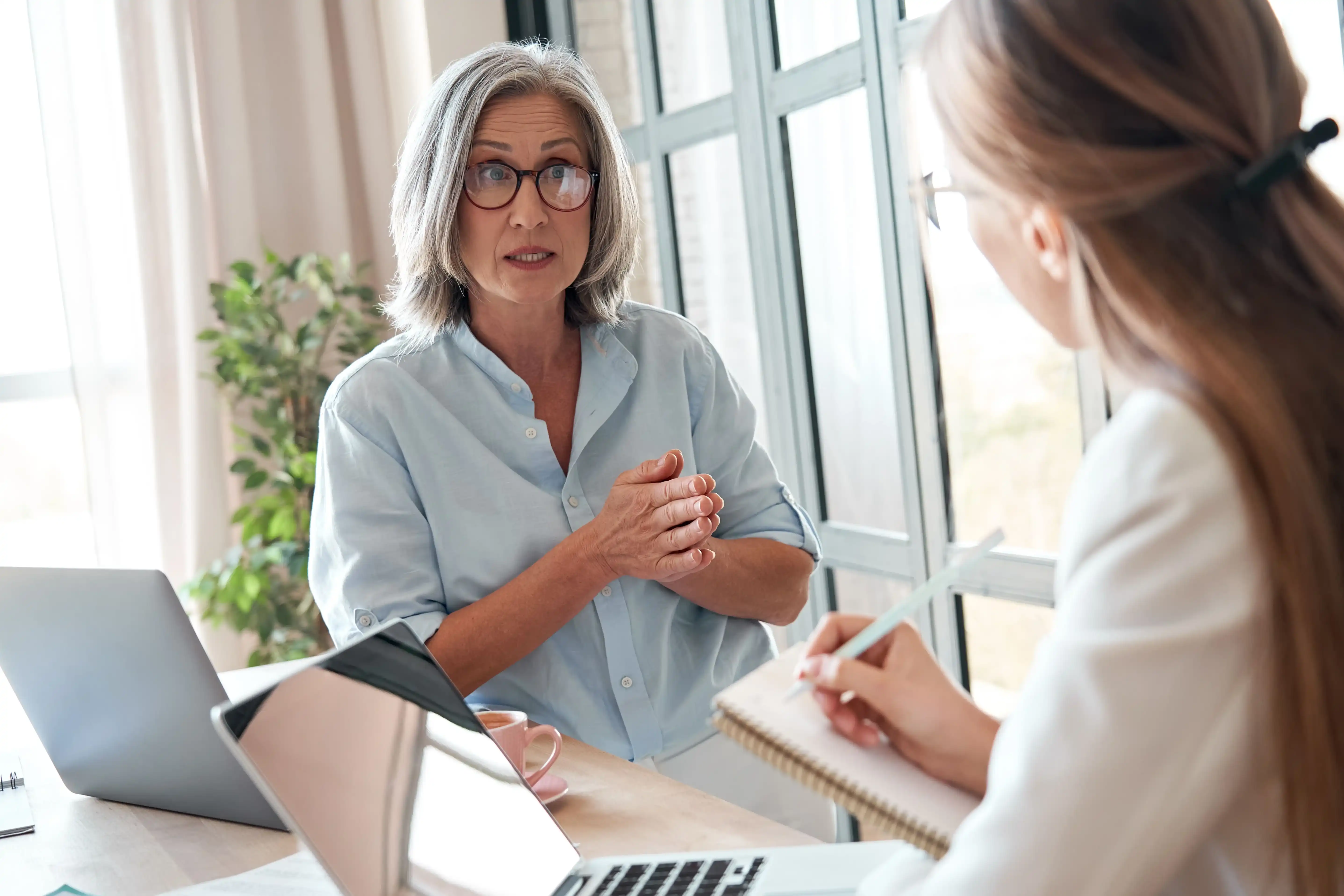A woman seeking professional advice from a financial advisor or credit counselor for managing multiple loans