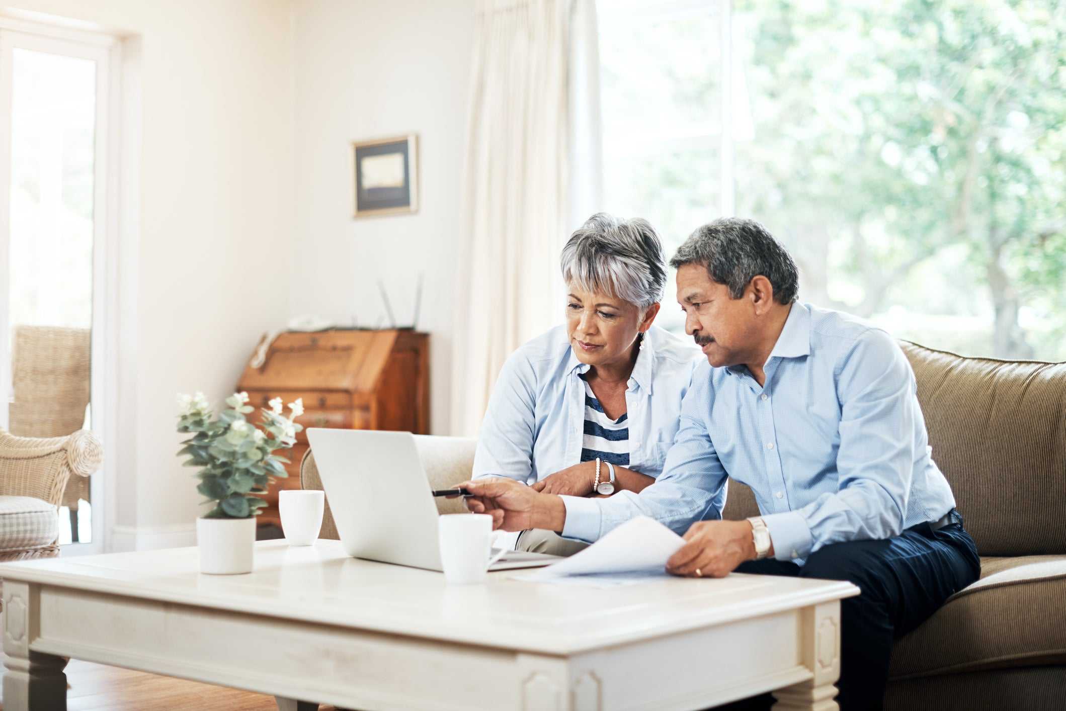 Elder couple preparing for retirement by budgeting their finances  