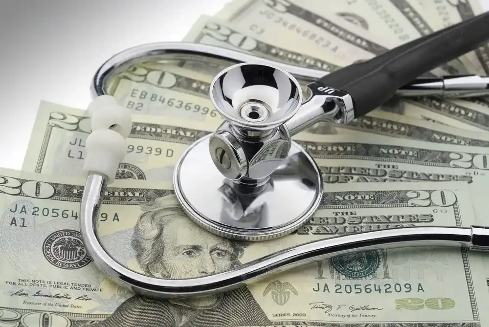 Stethoscope on money, representing an installment loan
