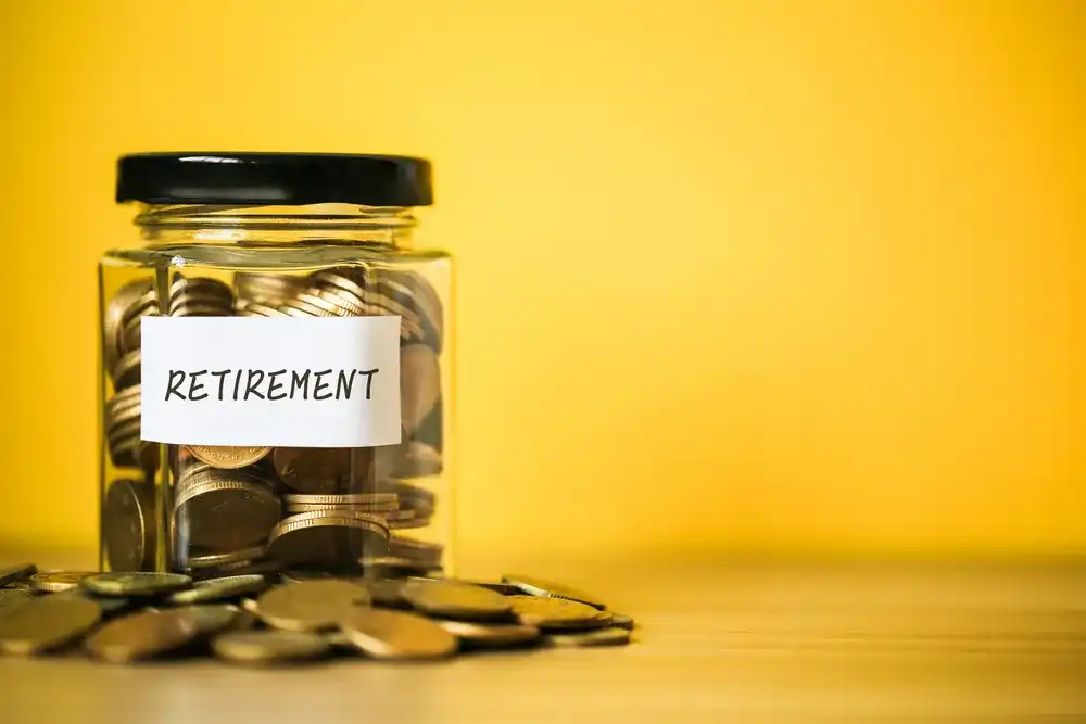 A jar full of money that reads "Retirement"