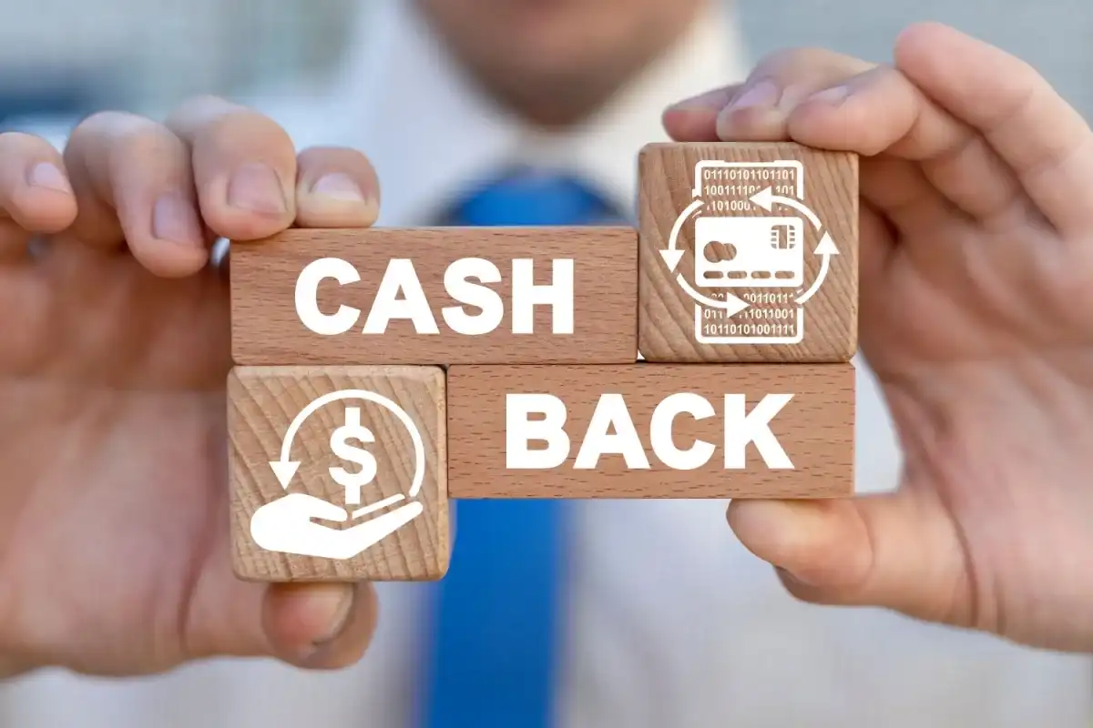 Person holding blocks that read "Cash Back" with money icons