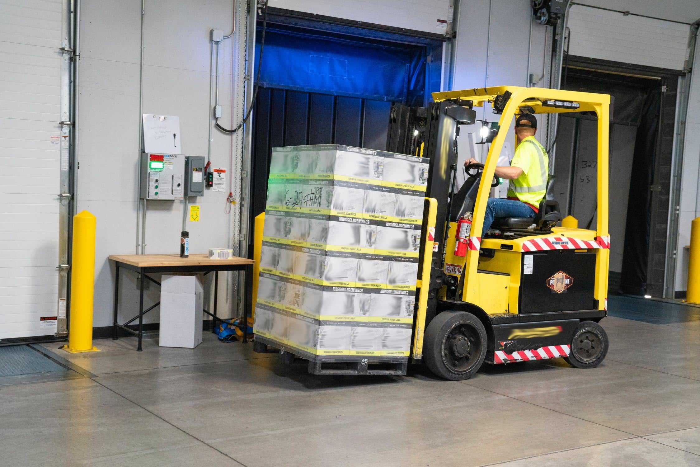 Forklift driver shown working at a warehouse earning cash as an essential worker.