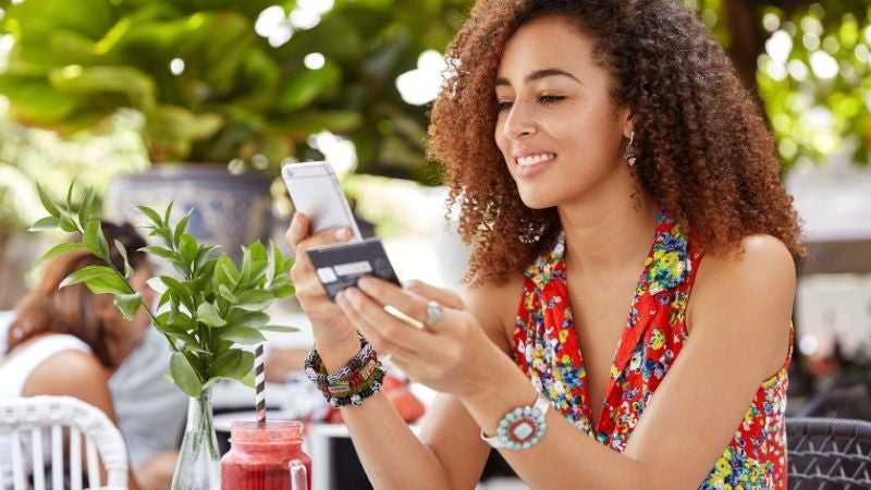 Woman making a payment on her installment loan with her credit card